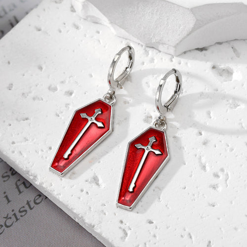 Close-up showing the colors and surface details of silver Tone Coffin and Cross Enamel Huggie Drop Earrings