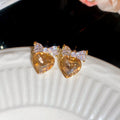 Gold Tone Crystal Heart Stud Earrings with Bow Details view 6