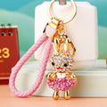 Jeweled Skirt Holding Rabbit Keychains in Pink and Purple view 3