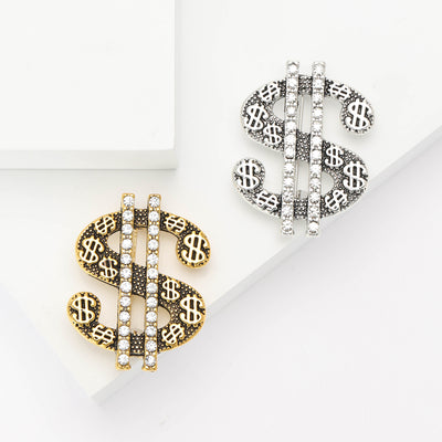 Front view of the dollar sign brooch
