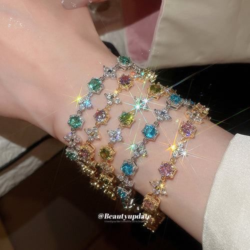Five multicolor hexagon crystal flower bracelets stacked on wrist