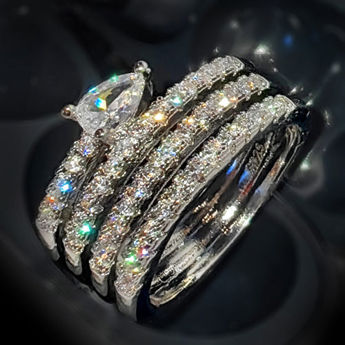 Pear multi-band wrap ring close-up on dark reflective surface
