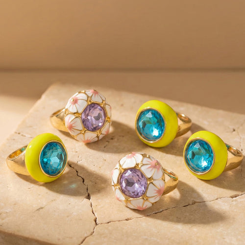 Grouped style view of enamel and faceted glass statement rings in main image 1.