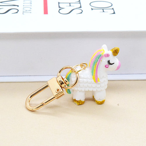 White resin unicorn keychain rainbow mane gold lobster clasp side view