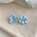 Pale Blue Five Petal Flower And Yellow Center Stud Earrings view 3