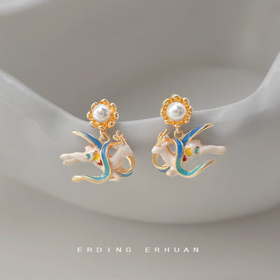 Gold-tone white-deer multicolor-enamel stud earrings in the first product display.