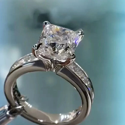 Styled view showing a square center, halo, and stone-set shoulders
