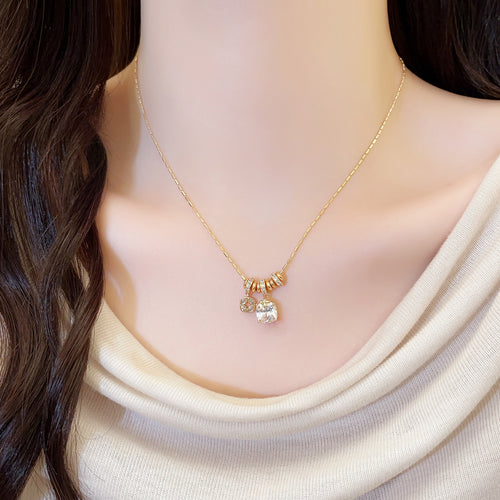 Styled close-up of the gold tone double crystal flower pendant chain necklace shown in image 1