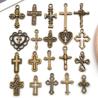Gold-tone cross charms arranged on a light background