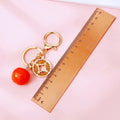 Coin and Persimmon Charm Keychains with Braided Wrist Loops view 5
