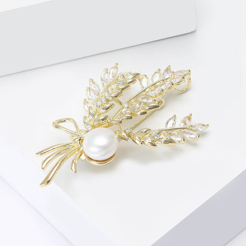 Angled view showing the wheat spray brooch surface