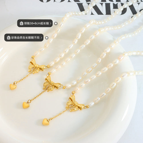 Three gold bow pearl necklaces on plate with length and pearl notes