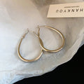 Slim Oval Statement Hoop Earrings in Gold and Silver Tones view 7