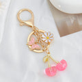 Cherry Charm Keychain with Enamel Butterfly and Daisy Flower Pendant view 7