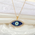 Gold Tone Crystal Halo Navy Evil Eye Pendant Necklace view 1