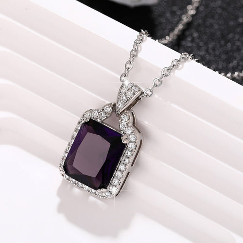 Side view of silver tone purple rectangle crystal pendant necklace