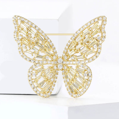 Yellow baguette crystal butterfly brooch on white blocks