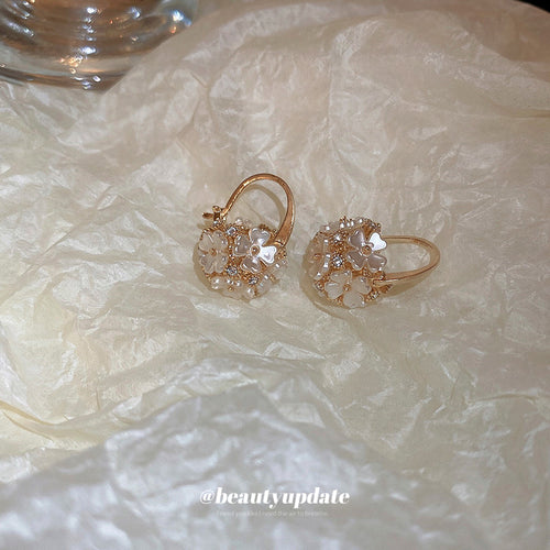 Gold Crystal Ball Huggie Hoop Earrings Polished Metal Jewelry modeled at the ear