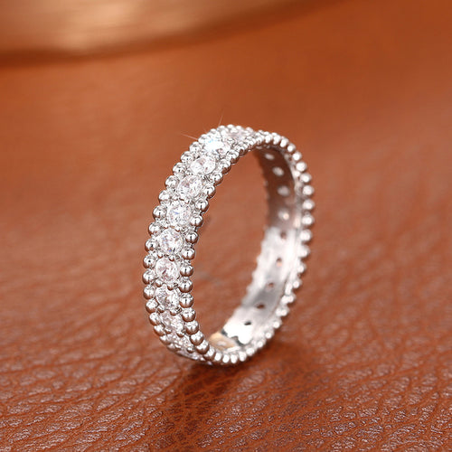 Silver-tone beaded-edge ring shown upright
