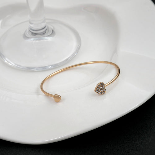 Cuff on white plate near wine glass stem