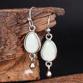 Silver Tone Oval Drop Earrings with Pale Green Centers view 2