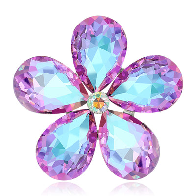 Purple Flower, Blue Flower brooch styles arranged on a light display