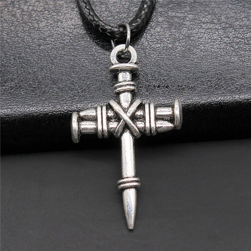 Front display of cross pendant necklaces on a light background