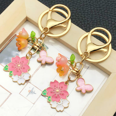 Main display of pink blossom butterfly and bell flower charm keychain