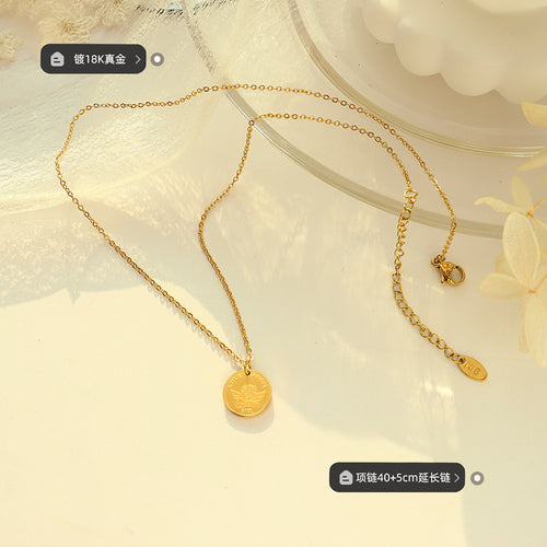 Gold angel disc necklace flat lay with plating and length labels