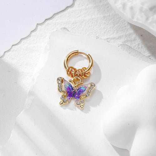 Purple galaxy wing butterfly charm on gold hoop with rhinestones