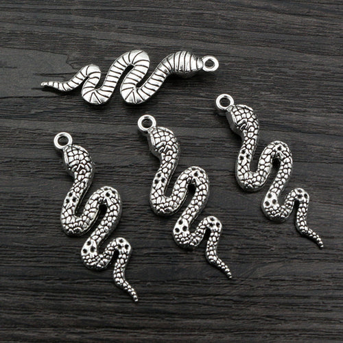 Finish comparison of textured snake metal charms in four size and finish options