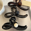 Gunmetal Tone Sculptural Loop Hair Claw With Large Round Bead Detail view 2