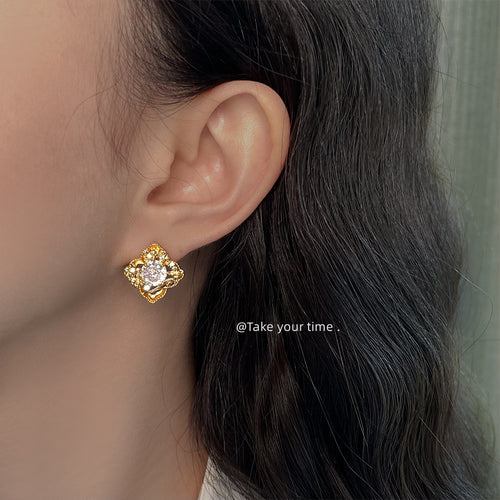 Gold floral crystal geometric stud worn on ear side profile