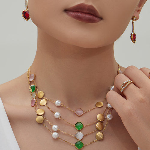 Neckline view of cat eye and imitation pearl station necklaces in main image 2.