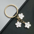 White Sakura Flower Enamel Charm Keychain with Gold Tone Ring view 2