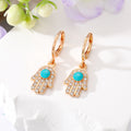 Gold Tone Crystal Hamsa and Evil Eye Huggie Drop Earrings view 2