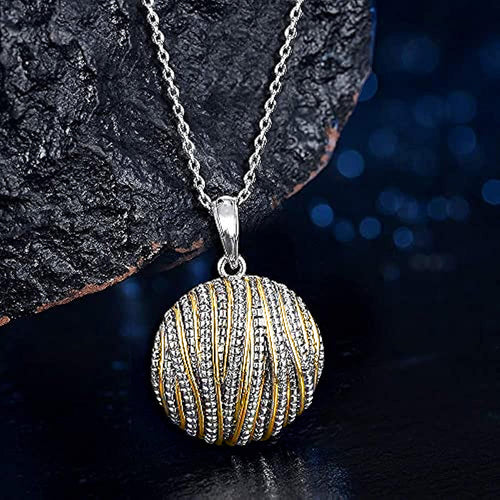 Angled detail view of silver and gold tone openwork sphere pendant necklace