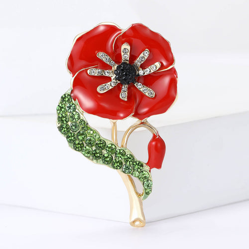 Red poppy brooch angled on white display block