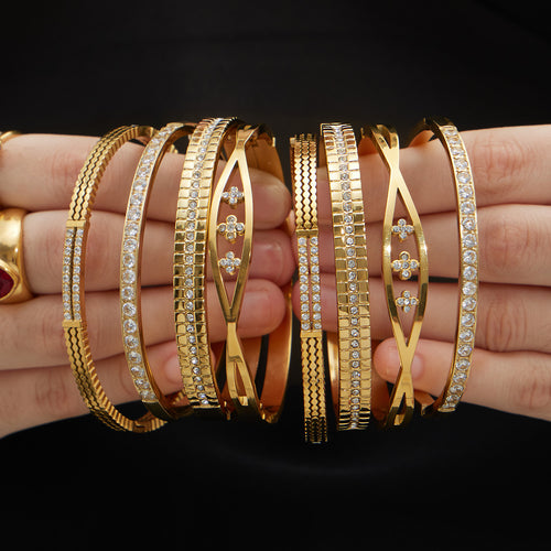 Mixed gold zircon bangle styles stacked on wrist