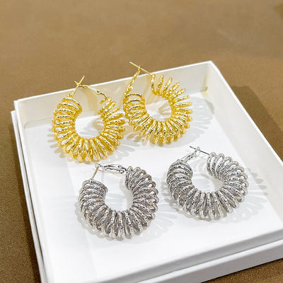 Gold and silver textured spring coil circular hoops in white tray