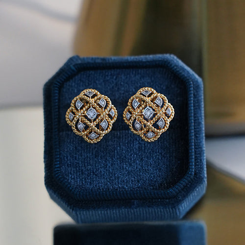 Gold dual-tone lattice flower stud earrings top view in box