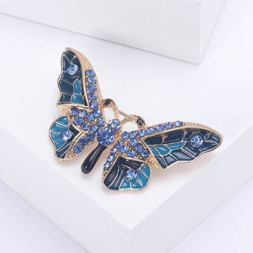 Blue enamel rhinestone butterfly brooch on white block