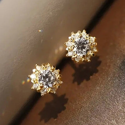 Product view showing round flower-like clusters of clear stones in silver and gold tones