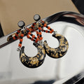 Black Gold Crescent Moon Orange Bead Dangle Earrings view 3