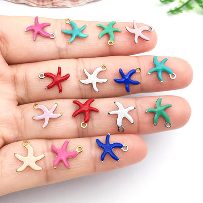 Gold-tone starfish charms arranged on a light background