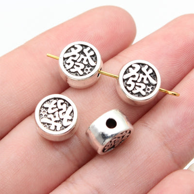 fa character round beads shown on fingertips for scale