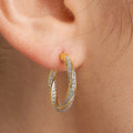 Gold Tone Crystal Twisted Oval Hoop Earrings Polished Metal Earrings view 3