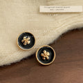 Black Enamel Round Camellia Stud Earrings Gold Rim view 3
