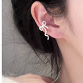 Wavy Bow Clip On Earrings in Silver and Gold Tone With Decorative Details view 3