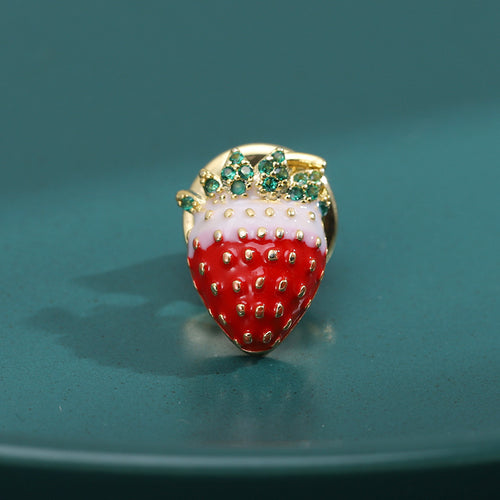 Gold-tone red white enamel strawberry pin with green crystals on teal plate
